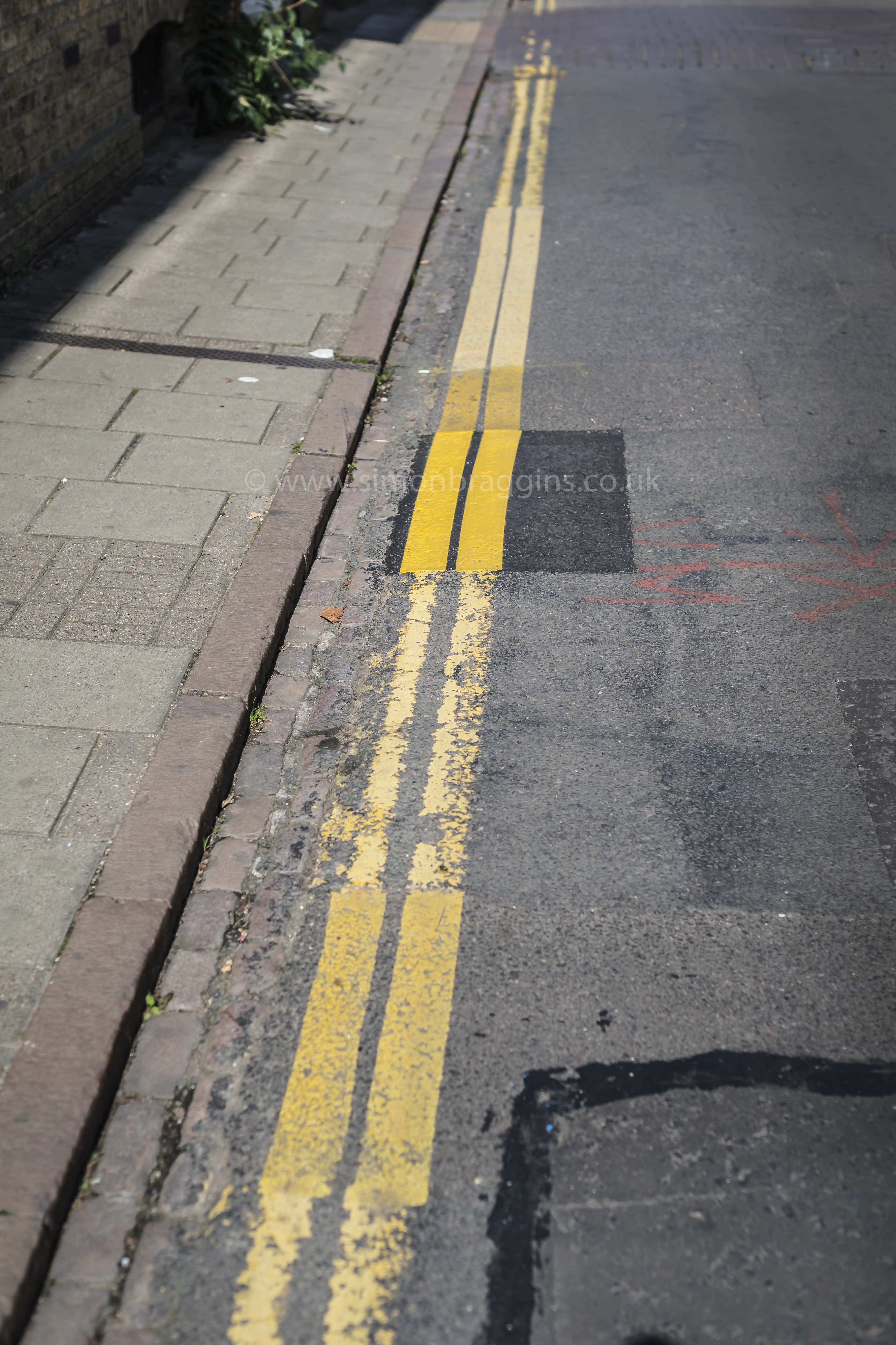 Scars : the yellow lines on an everyday road show the many repair patches - September 2016